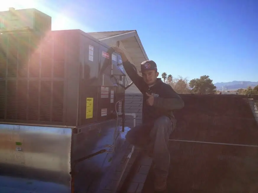 HVAC technician performing Boiler Repair on a rooftop unit in Valparaiso